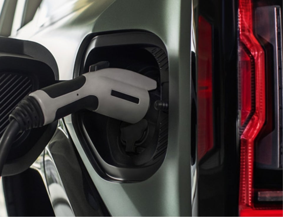 Close up of charging port with charger plugged in on a GMC Hummer EV SUV - Courtesy GMC of Ruston in RUSTON LA